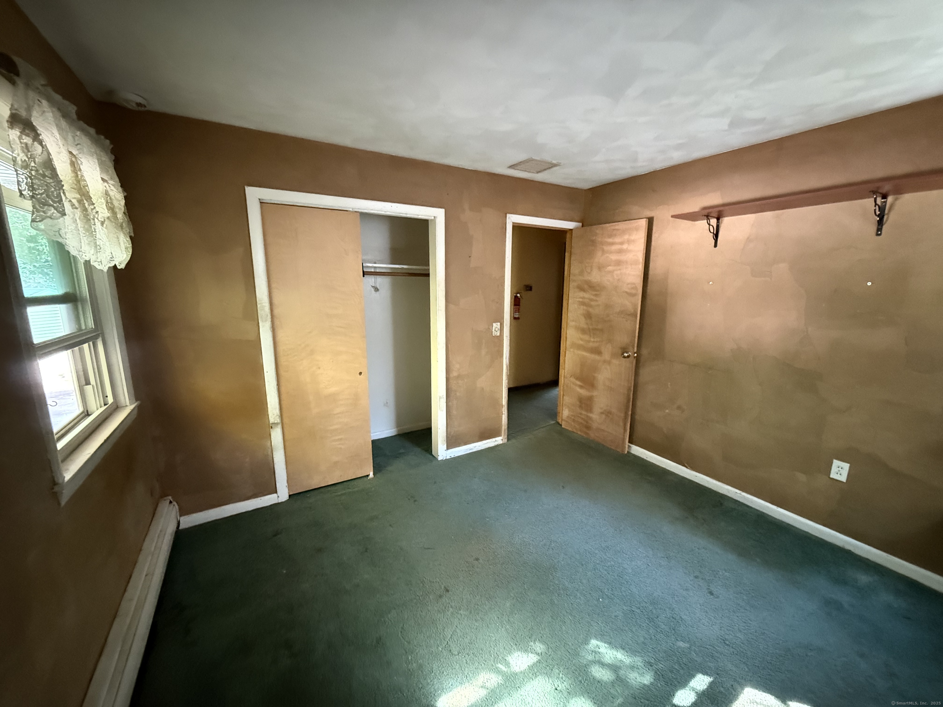 9 Deerbrook Road Norwich, CT 06360 - Photo 5 of 10 an empty room with windows