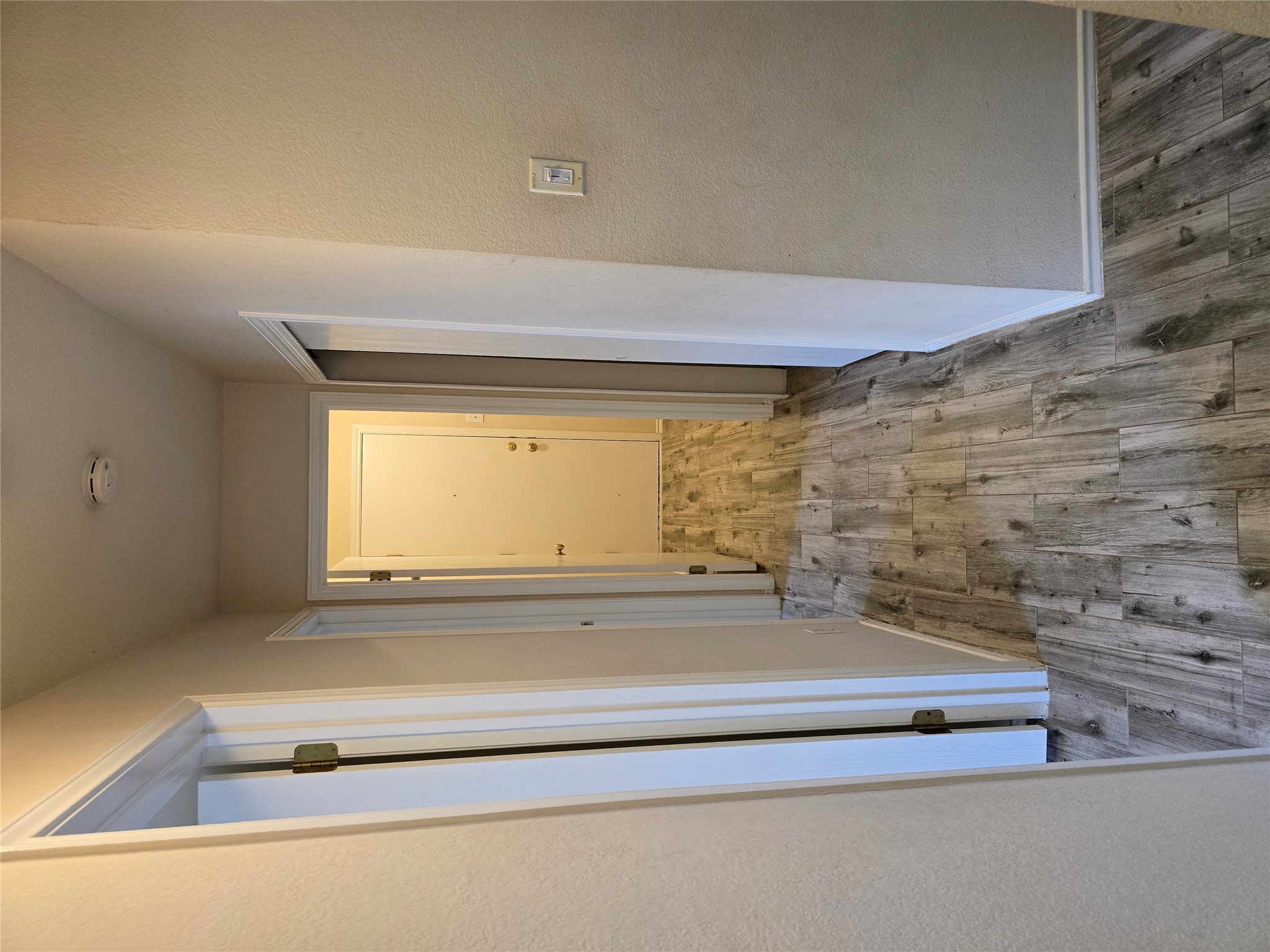 2011 Garrison Drive Leander, TX 78641 - Photo 13 of 23 Hallway leading to two additional bedrooms on the left, closet on the right and laundry room down the middle with door to the garage