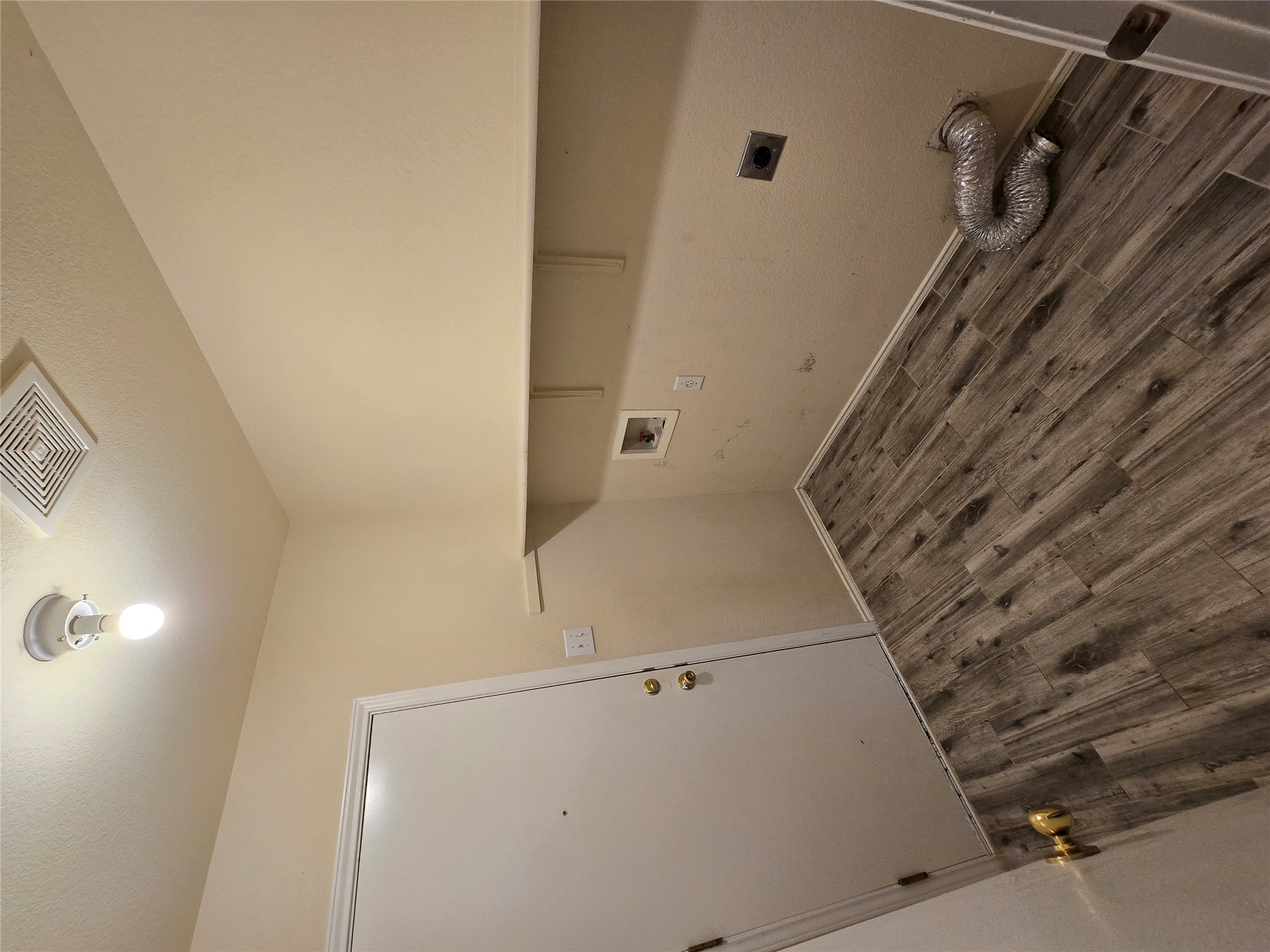 2011 Garrison Drive Leander, TX 78641 - Photo 19 of 23 Laundry area with washer and electric dryer hookup. Storage shelf up top and door to the garage.