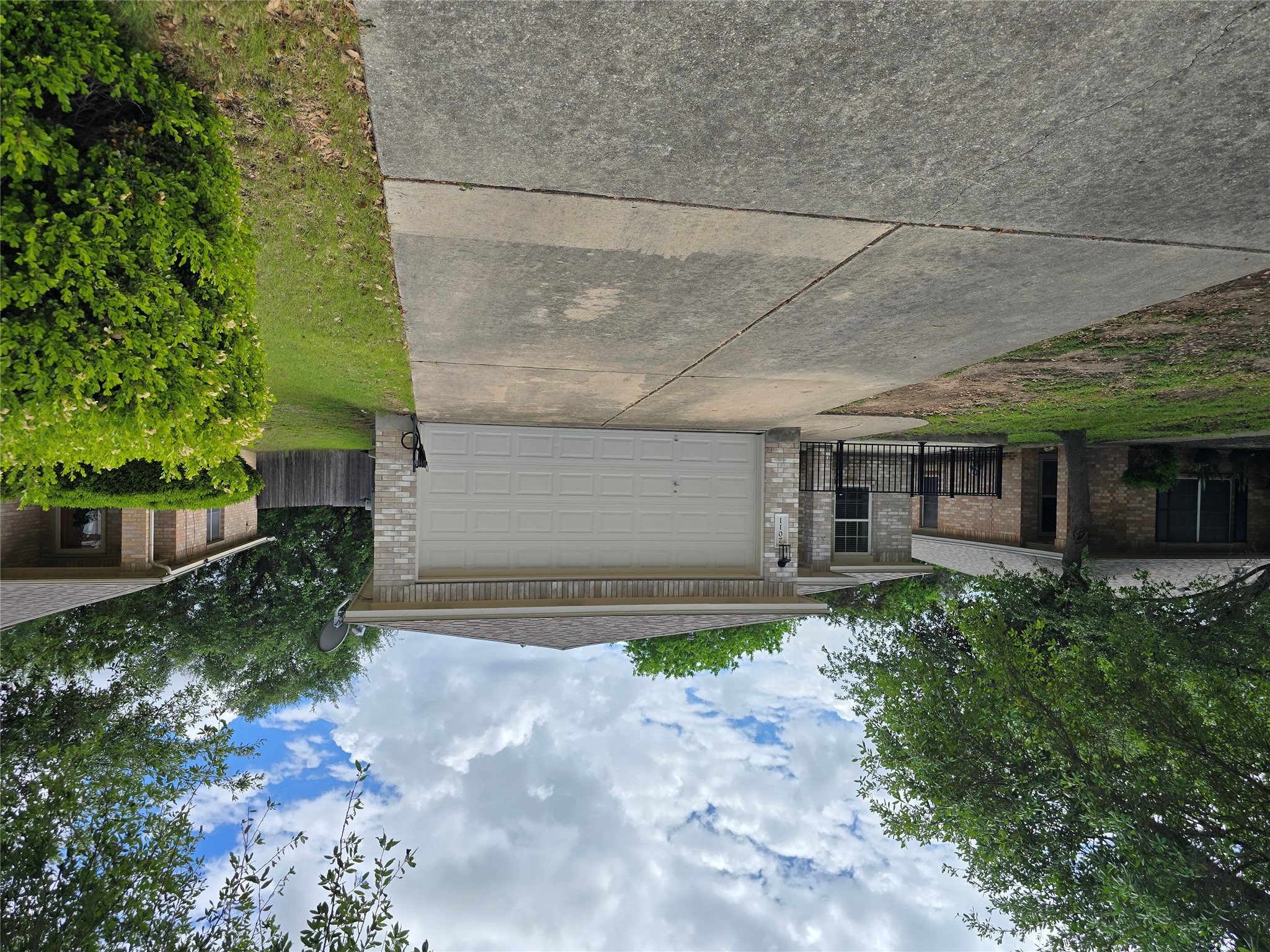 2011 Garrison Drive Leander, TX 78641 - Photo 2 of 23 Ranch-style house with brick siding, concrete driveway, an attached garage, and a shingled roof