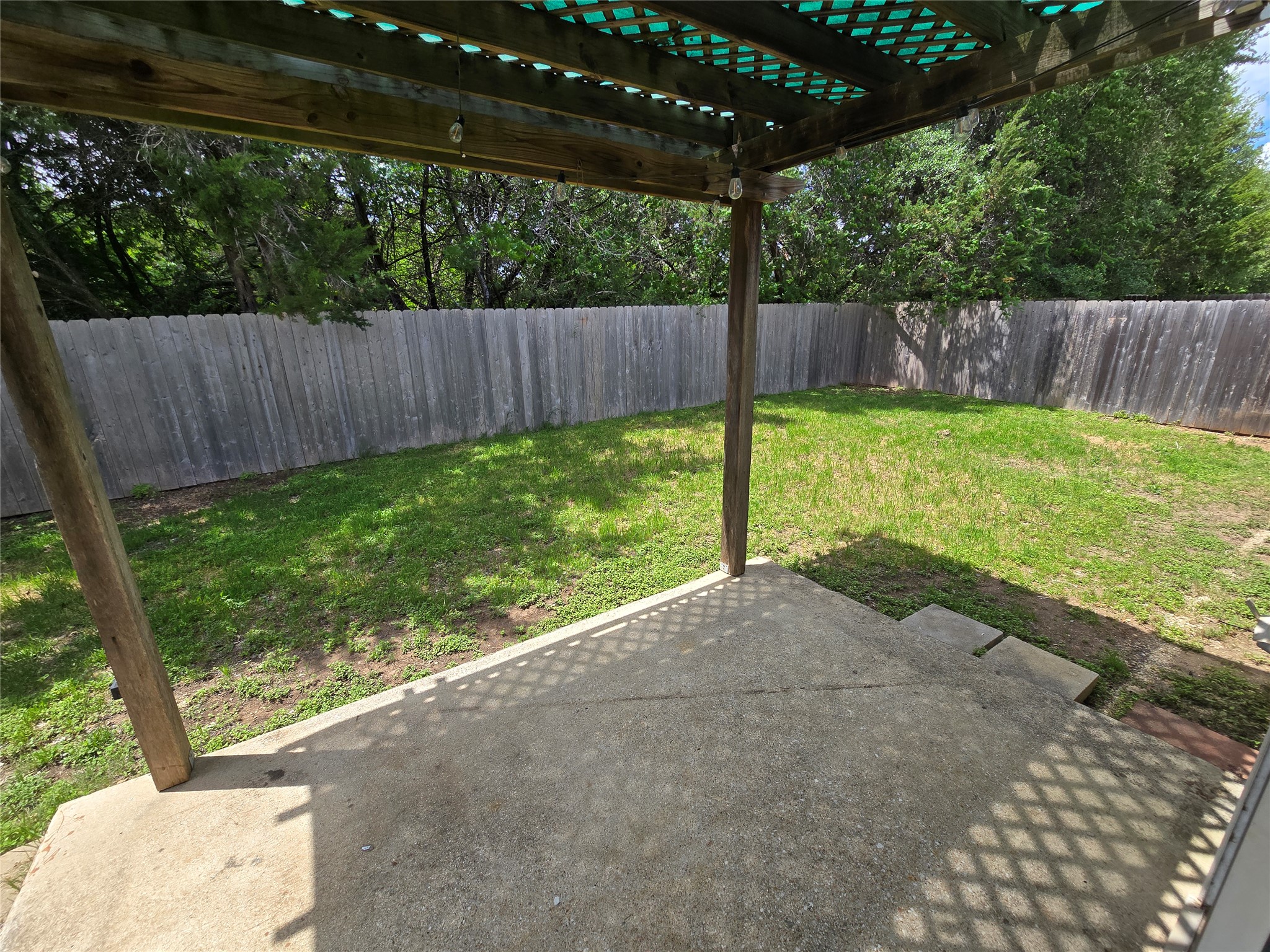 2011 Garrison Drive Leander, TX 78641 - Photo 21 of 23 Fenced backyard with a covered patio area and a pergola
