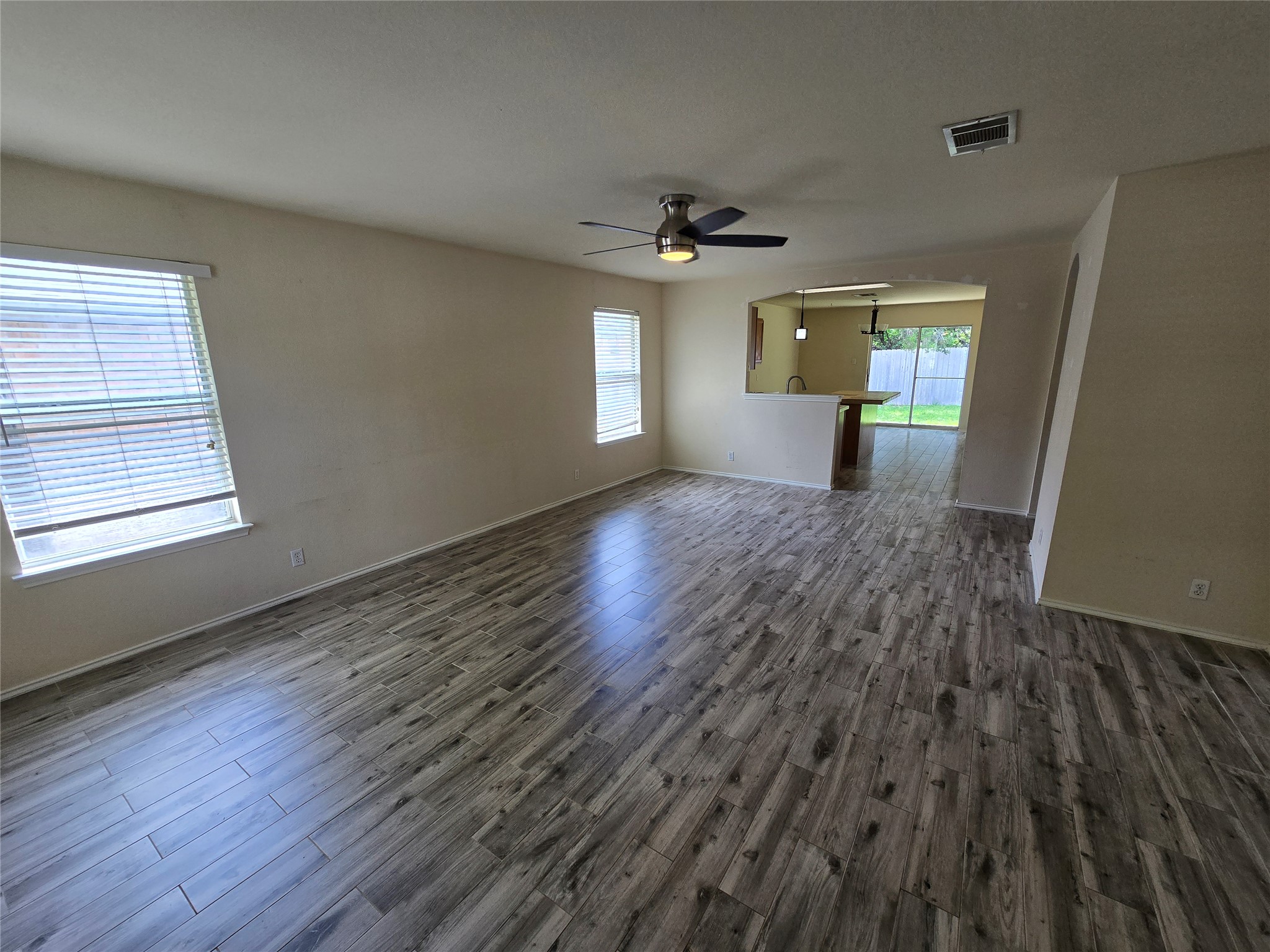 2011 Garrison Drive Leander, TX 78641 - Photo 4 of 23 Living room featuring a ceiling fan, neutral wood finished floors and plenty of natural light