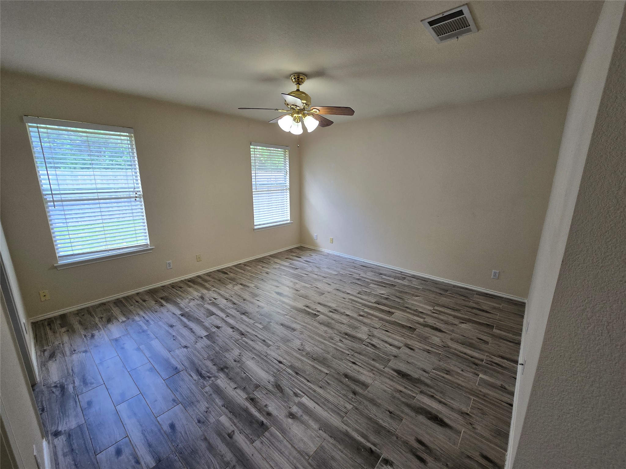 2011 Garrison Drive Leander, TX 78641 - Photo 8 of 23 Primary bedroom with a ceiling fan on the backside of the home with views of the fenced in yard