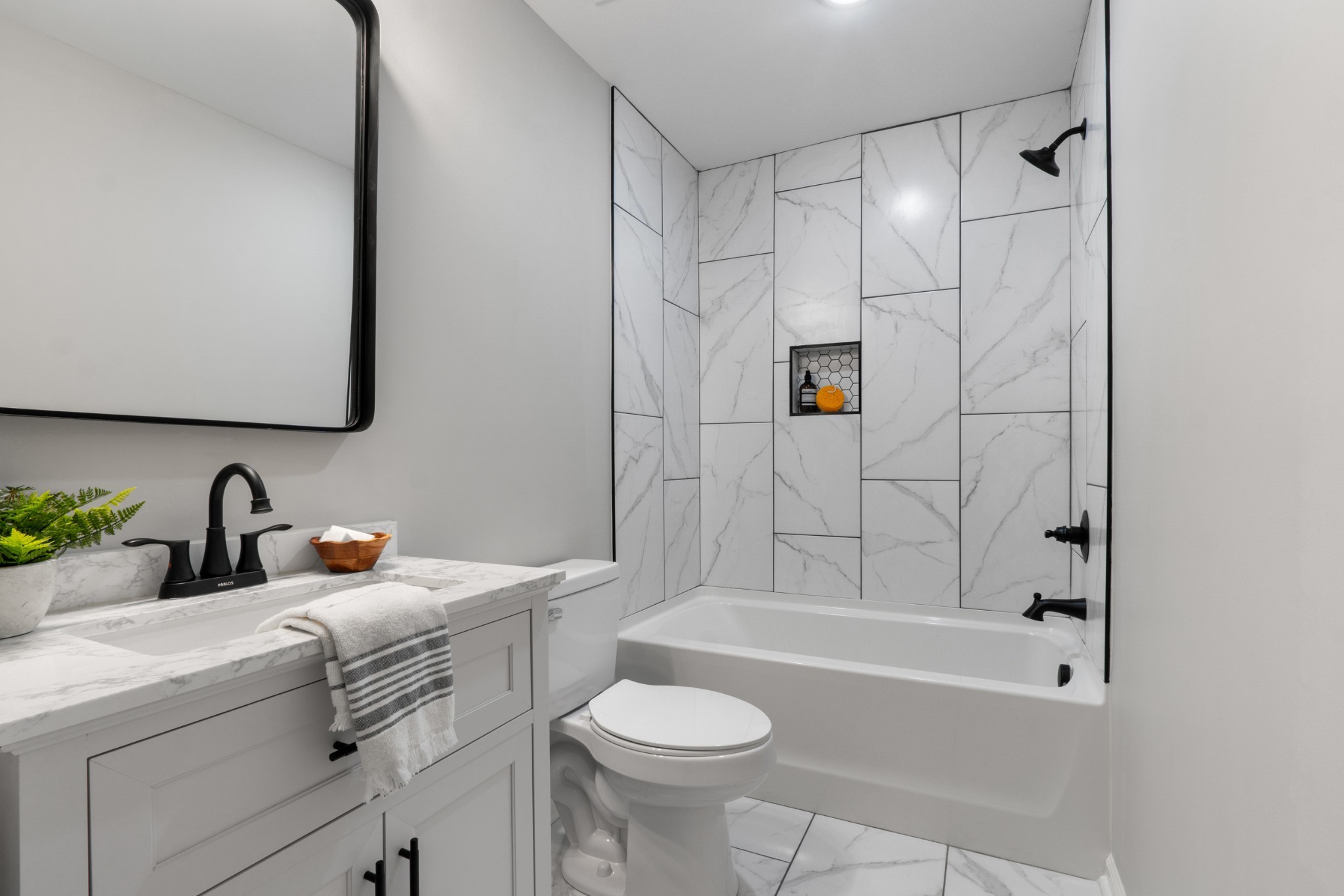 311 South Walnut Street, Unit H Mount Pleasant, TN 38474 - Photo 14 of 22 a bathroom with a sink toilet and shower