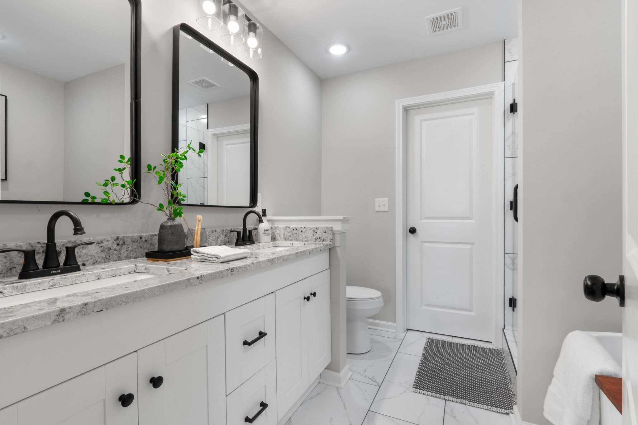 311 South Walnut Street, Unit H Mount Pleasant, TN 38474 - Photo 15 of 22 a bathroom with a granite countertop sink mirror and a toilet