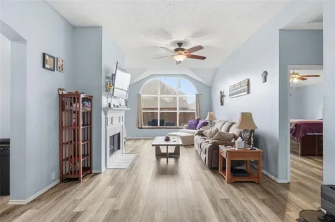 a living room with furniture a table and a large window
