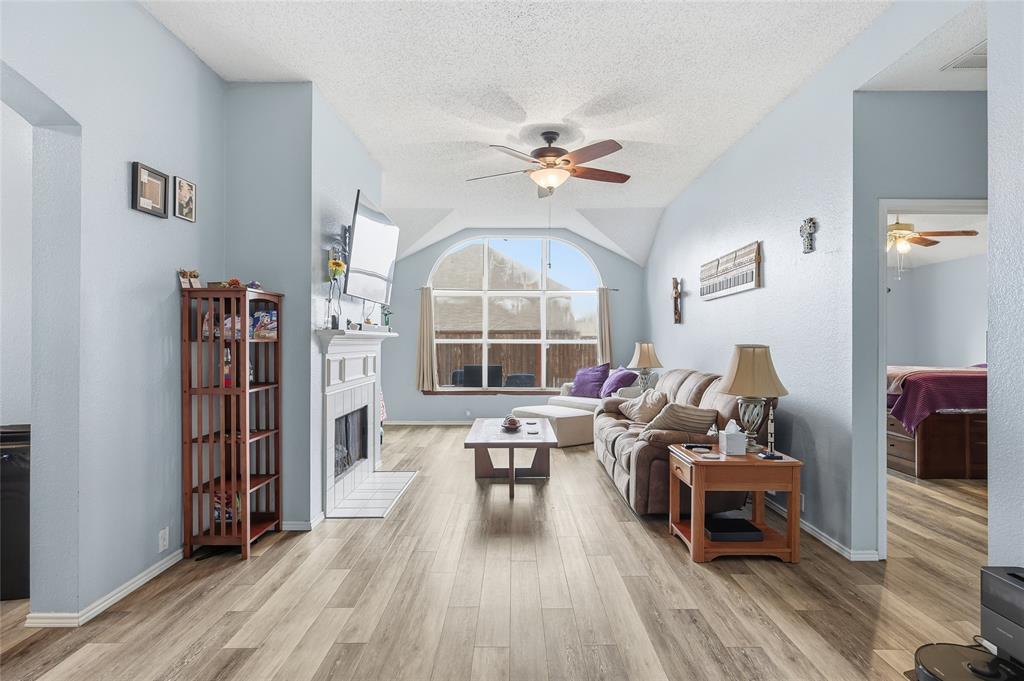 a living room with furniture a table and a large window