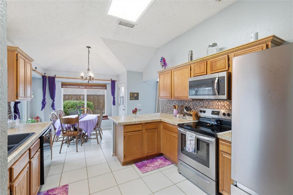 763 Winding Oak Bend Lake Dallas, TX 75065 - Photo 11 of 25 a kitchen with a sink stove and cabinets