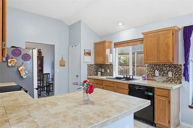 a kitchen with a sink stove and refrigerator