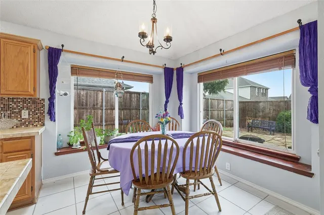 a view of a dining room with furniture large windows and wooden floor