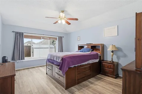 a spacious bedroom with a bed and a window