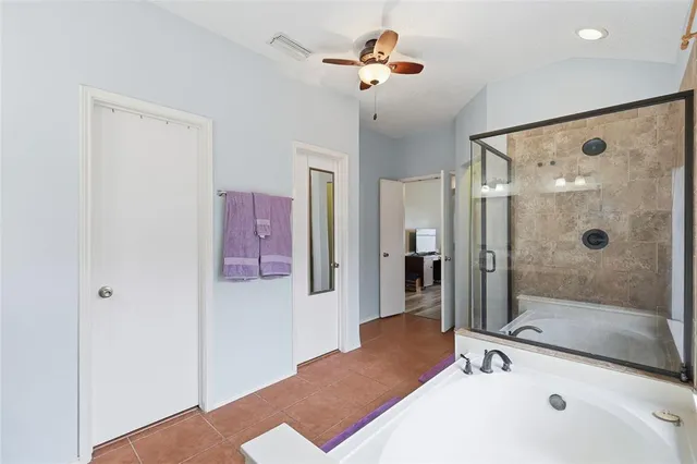 a bathroom with a tub sink and shower