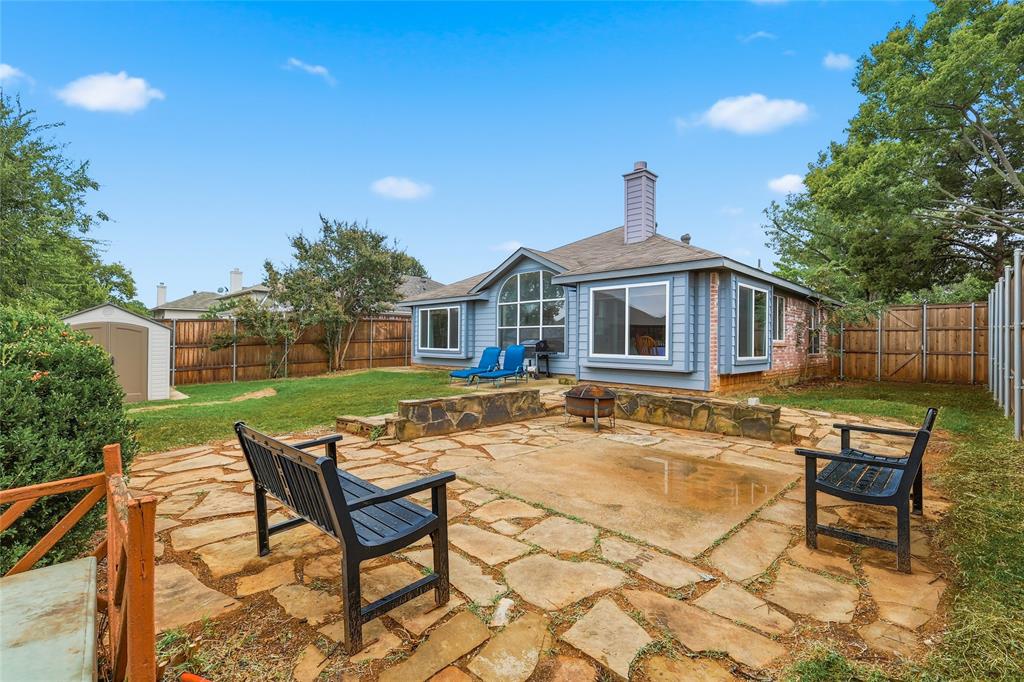 763 Winding Oak Bend Lake Dallas, TX 75065 - Photo 23 of 25 a backyard of a house with table and chairs