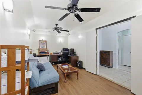 a living room with furniture and a ceiling fan