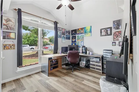 a view of a workspace with furniture and a window