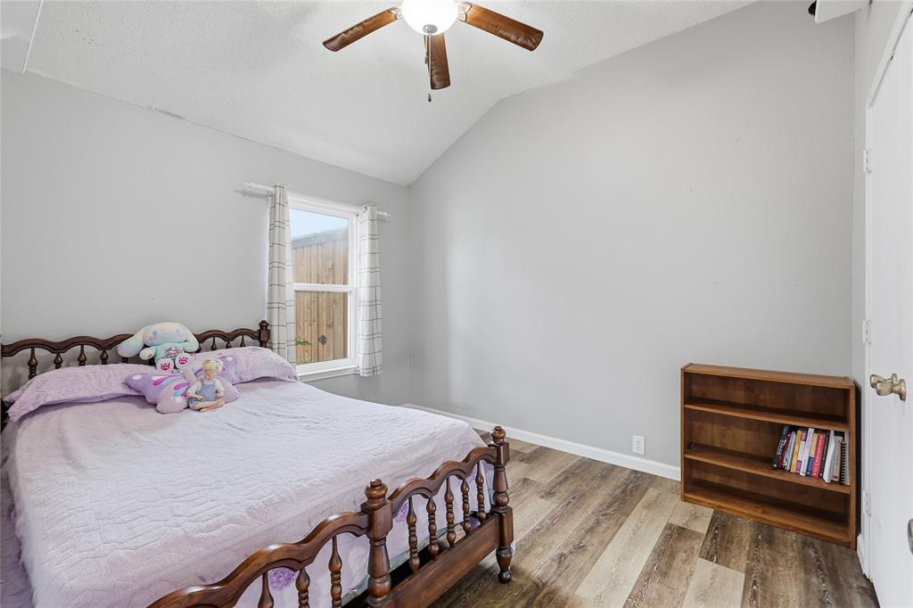 763 Winding Oak Bend Lake Dallas, TX 75065 - Photo 8 of 25 a bedroom with a bed and a chandelier