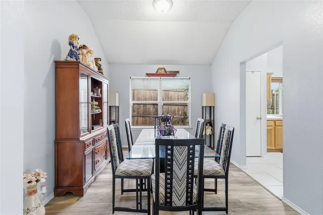 a view of a dining room with furniture and a window