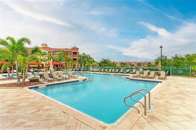 a view of a swimming pool with outdoor seating