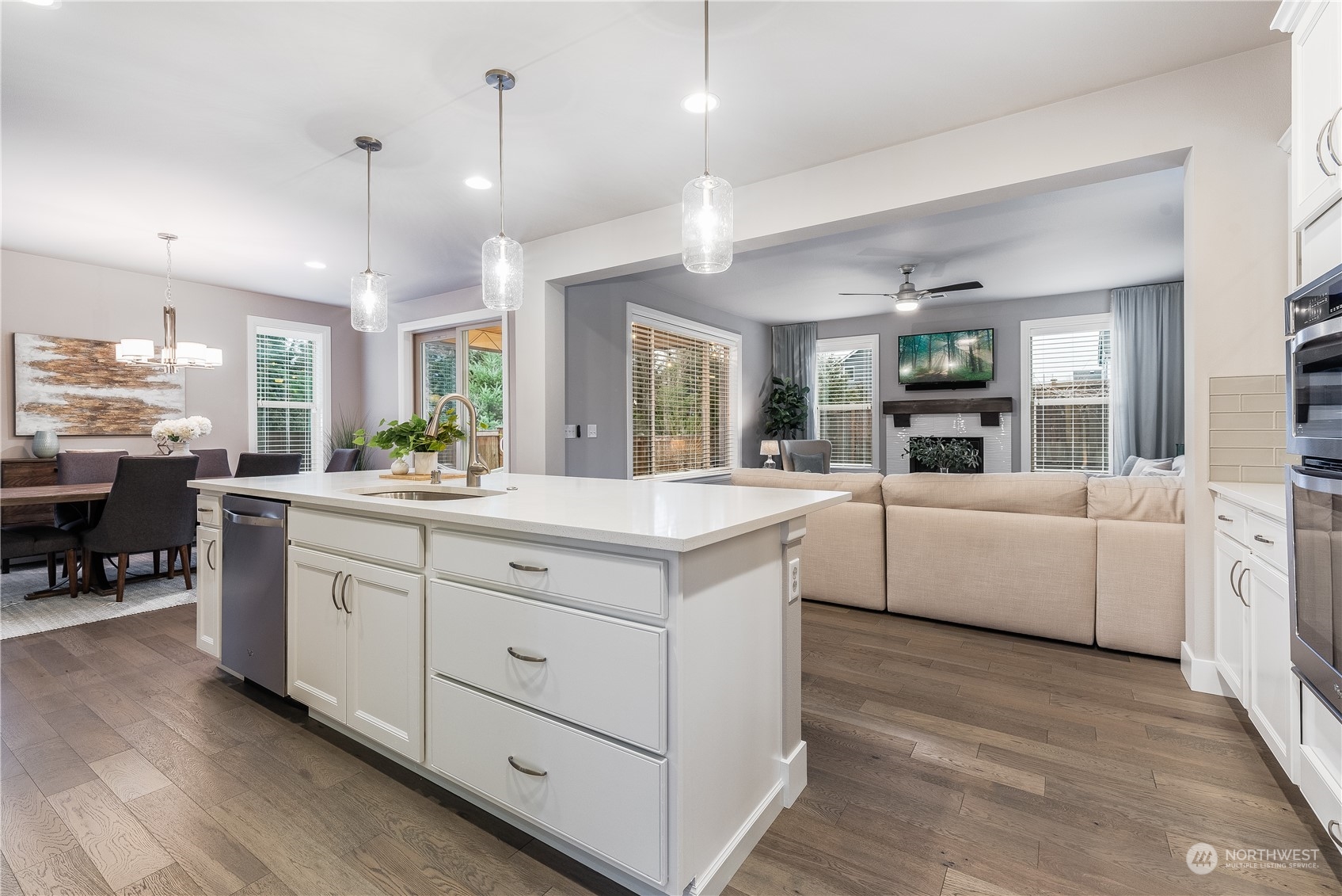 4105 Strumme Road Bothell, WA 98012 - Photo 12 of 40 a large white kitchen with kitchen island a white cabinets and chandelier
