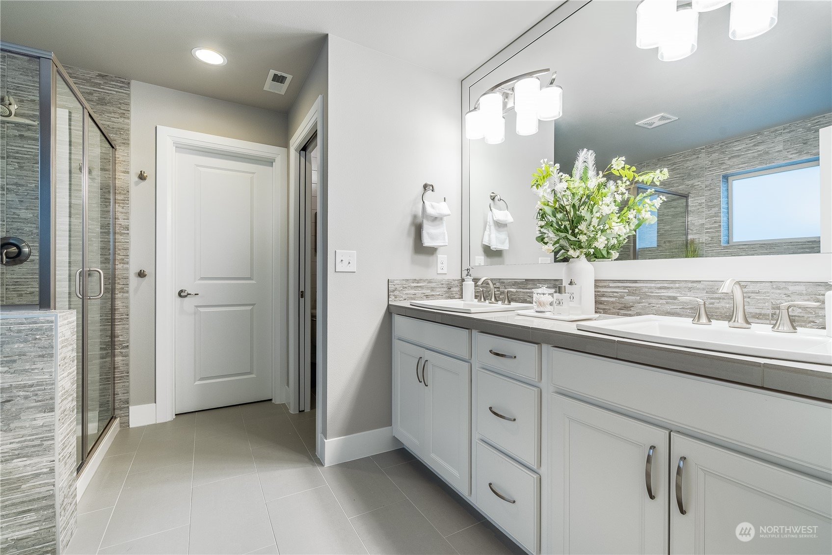 4105 Strumme Road Bothell, WA 98012 - Photo 31 of 40 a bathroom with a double vanity sink and mirror