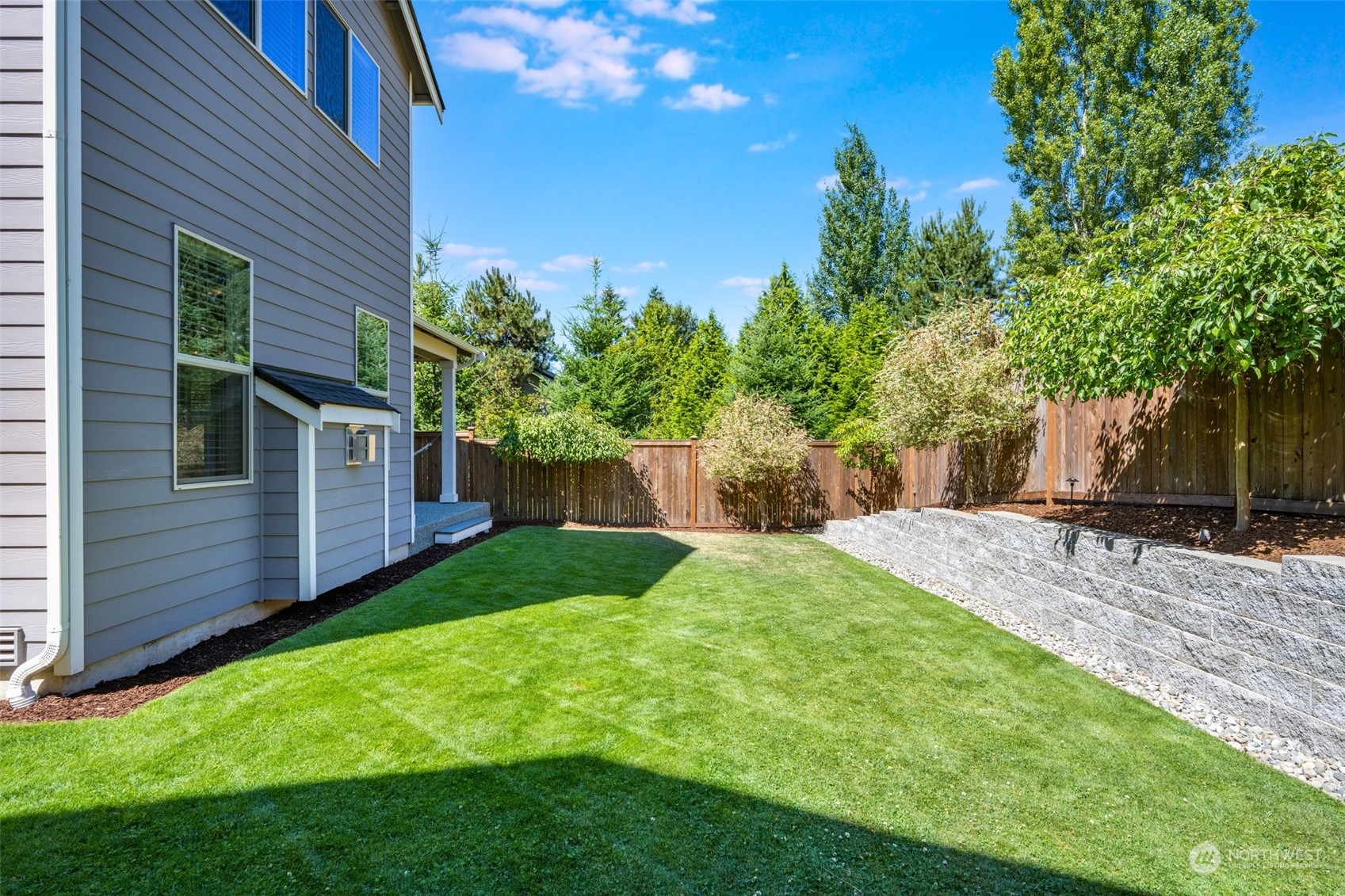 4105 Strumme Road Bothell, WA 98012 - Photo 39 of 40 a view of a backyard with plants and large trees