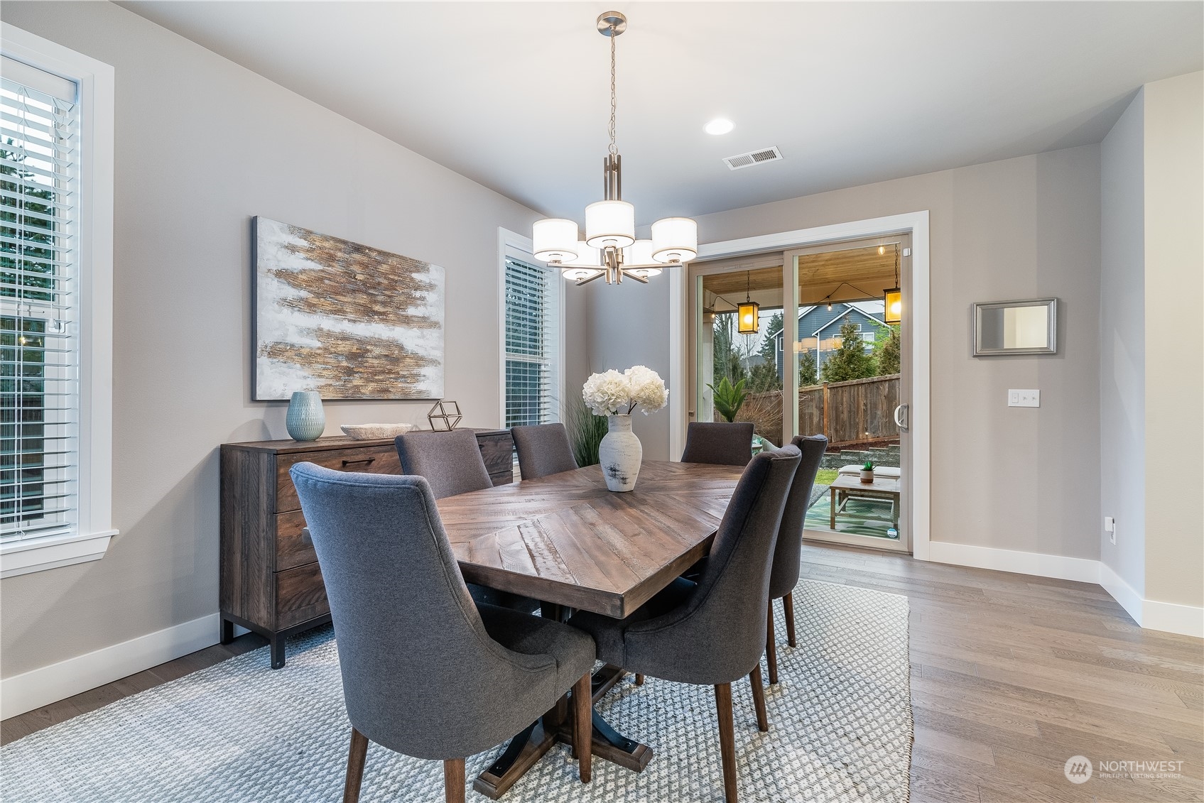 4105 Strumme Road Bothell, WA 98012 - Photo 5 of 40 a dining room with furniture a chandelier and wooden floor