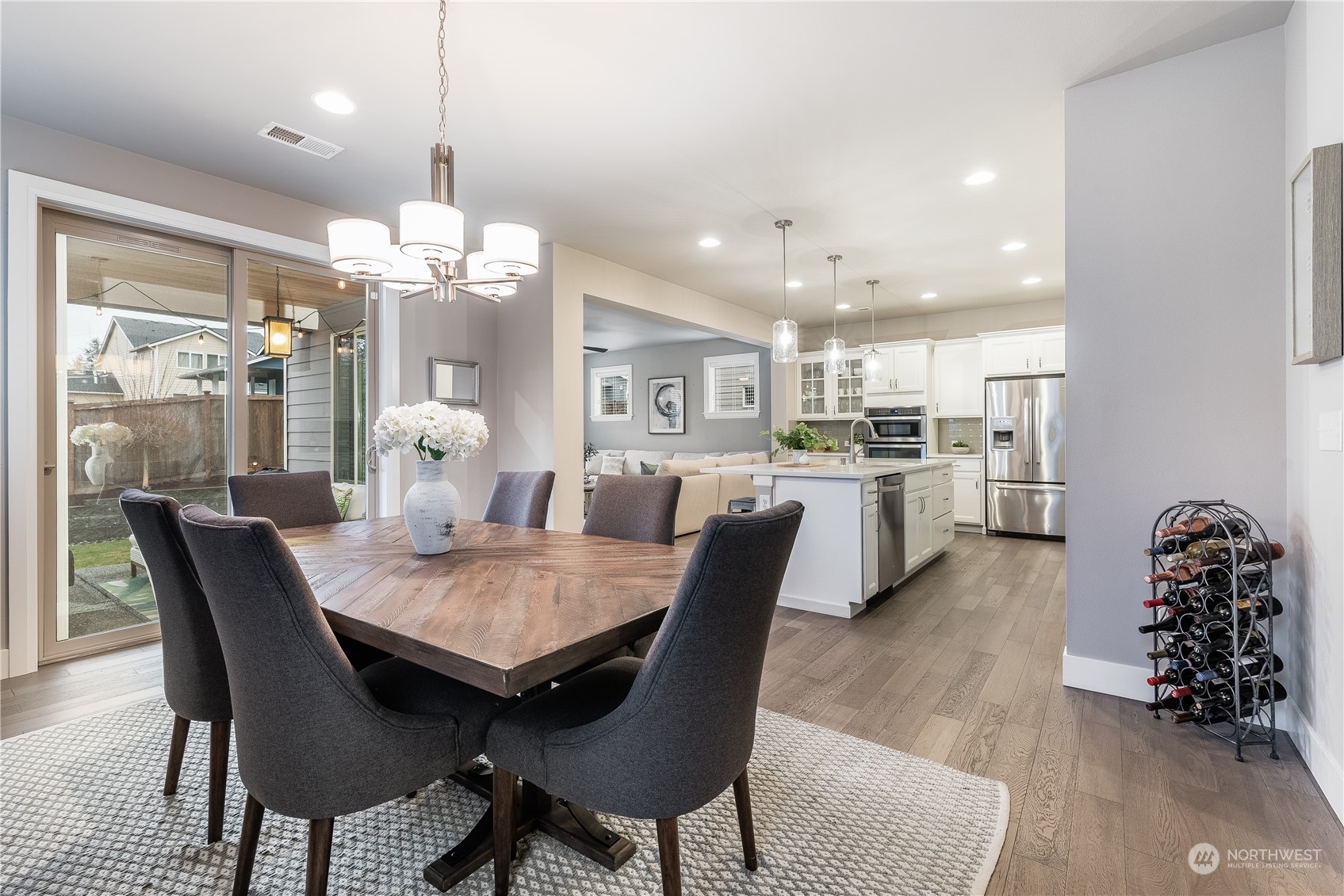 4105 Strumme Road Bothell, WA 98012 - Photo 6 of 40 a dining room filled chandelier and wooden furniture