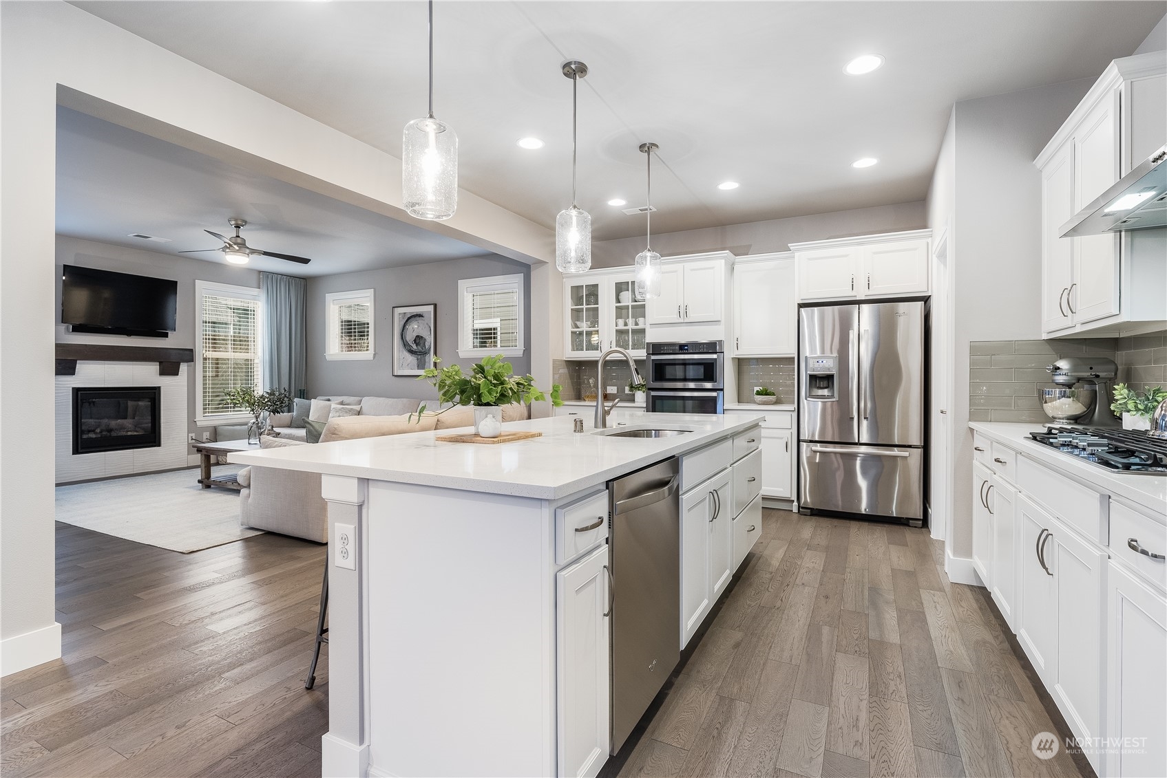 4105 Strumme Road Bothell, WA 98012 - Photo 8 of 40 a large kitchen with stainless steel appliances kitchen island granite countertop a large counter top and stainless steel appliances