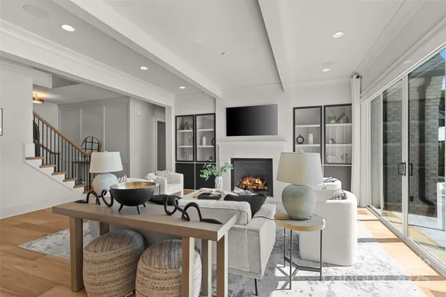 a living room with furniture a fireplace and a flat screen tv