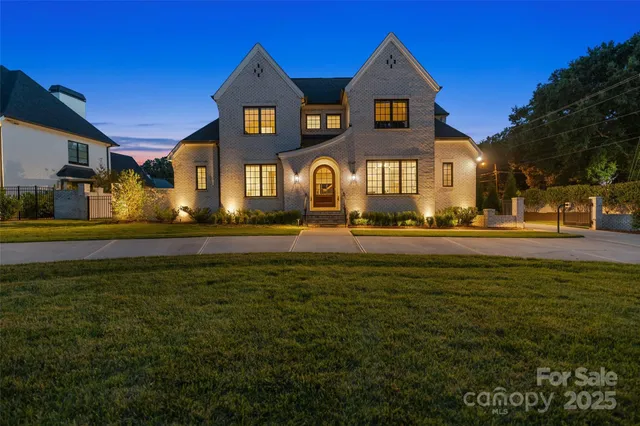 a front view of a building with lot of trees