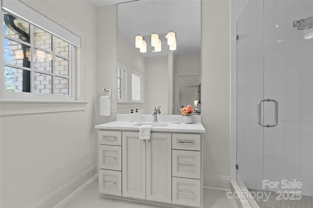 a bathroom with a sink vanity granite and a mirror