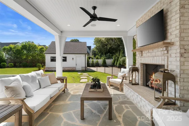 a front view of a house with swimming pool having outdoor seating