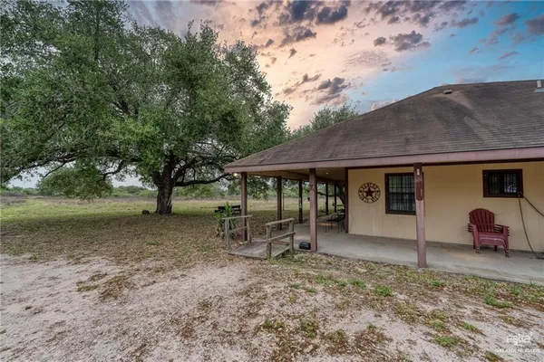 a spacious bedroom with a bed and a chandelier