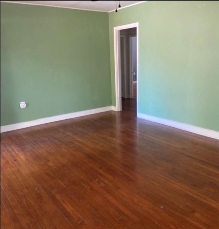 603 West Avenue F Avenue Kingsville, TX 78363 - Photo 2 of 5 a view of an empty room with wooden floor