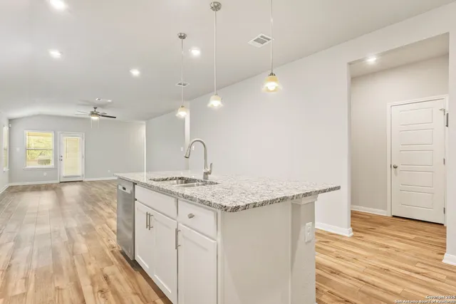 a kitchen with a sink and chandelier