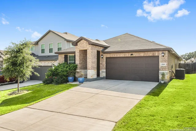 a front view of a house with a yard and garage