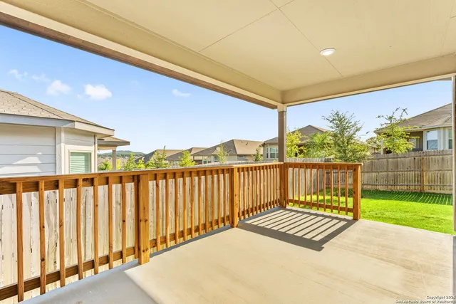a view of a balcony with wooden floor