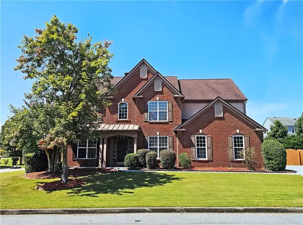 a front view of a house with a yard