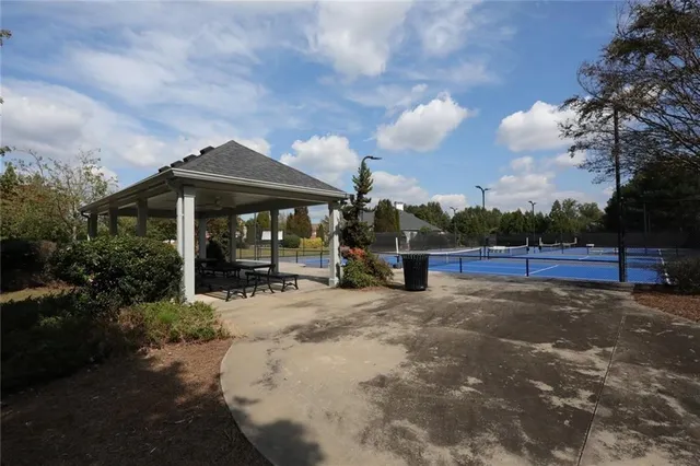 a view of a patio with table and chairs under an umbrella