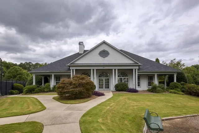 a front view of house with yard outdoor seating and barbeque oven