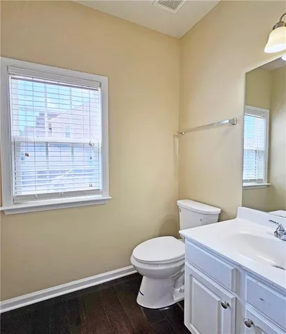 a white toilet sitting next to a bathroom sink