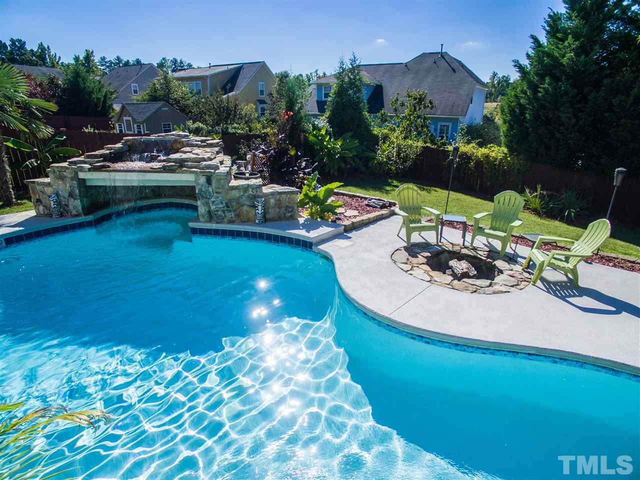 10125 Darling Street Raleigh, NC 27613 - Photo 3 of 25 a view of a swimming pool with a patio and a garden