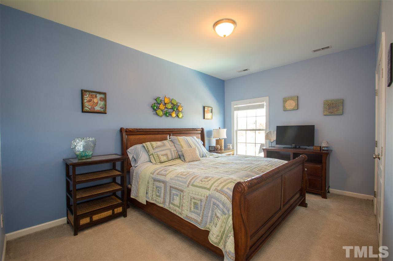 10125 Darling Street Raleigh, NC 27613 - Photo 22 of 25 a bedroom with a bed and a couch