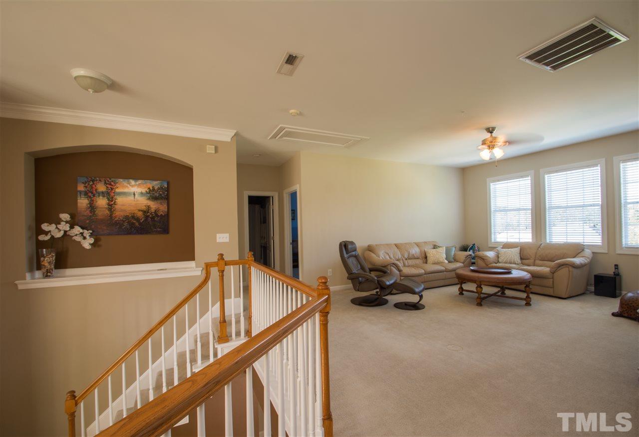 10125 Darling Street Raleigh, NC 27613 - Photo 23 of 25 a living room with furniture and a flat screen tv