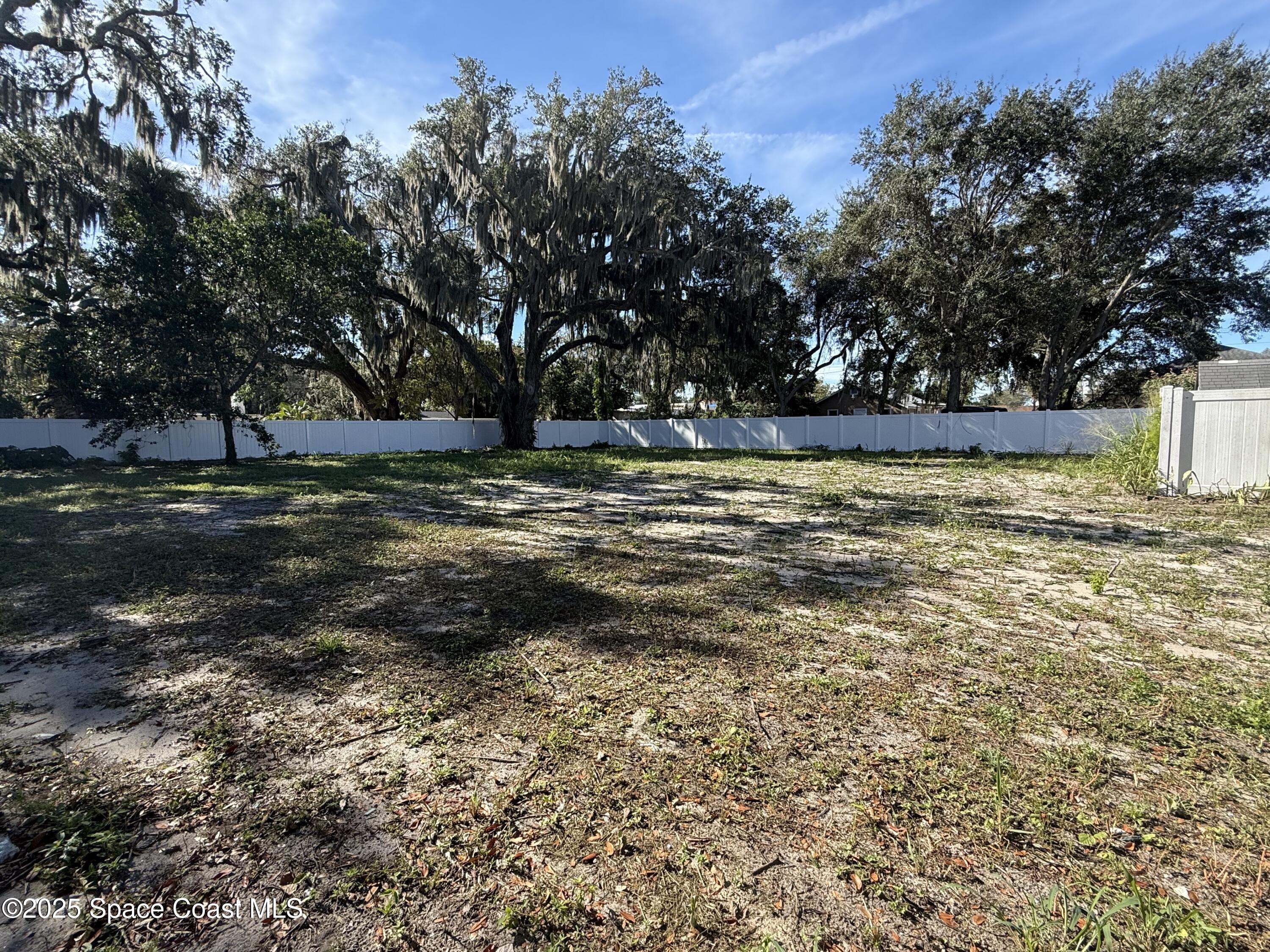 213 Sweet Street Rockledge, FL 32955 - Photo 7 of 24 a view of a yard with large trees