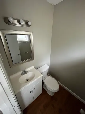 a bathroom with a toilet sink and mirror