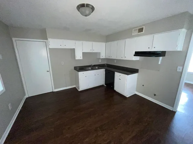 a kitchen with a sink and a refrigerator