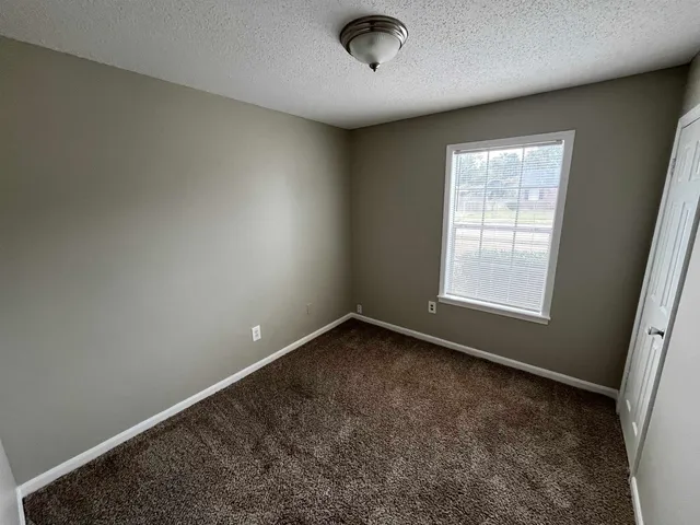 an empty room with a empty space and windows