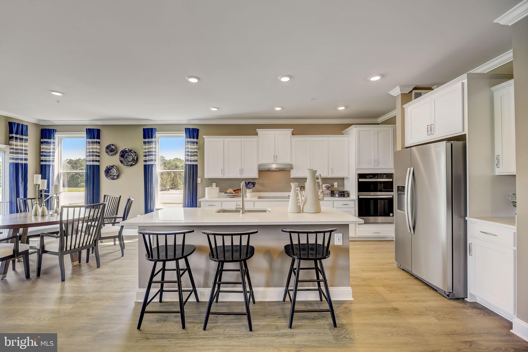 64 Buttercup Circle Elkton, MD 21921 - Photo 14 of 48 a kitchen with stainless steel appliances kitchen island granite countertop a dining table chairs and refrigerator