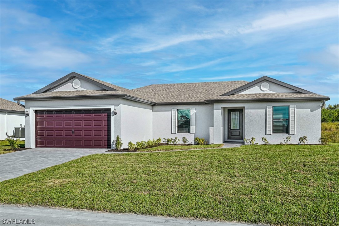 890 General Chesty Puller Court LaBelle, FL 33935 - Photo 2 of 22 a front view of a house with a yard